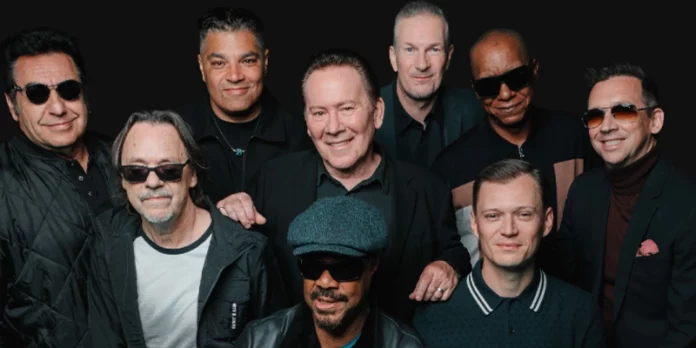 Miembros de UB40 posando juntos en una sesión fotográfica previa a su concierto en España